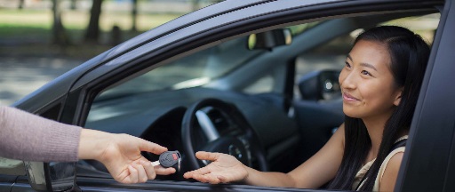 happy girl with car keys GettyImages-2178144748 link to What to Know When Buying a Car